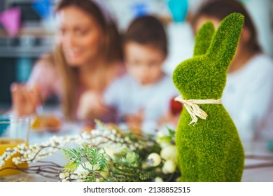 Happy young family decorating Easter eggs. Happy family spending time together during Easter holiday at home.  Two cute kids painting easter eggs with mom and dad.  - Powered by Shutterstock