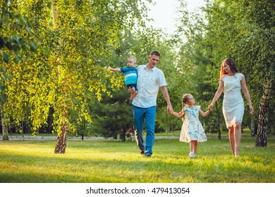 Smiling Family Running Across Summer Field Stock Photo (Edit Now) 290606003