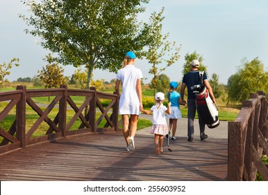 Happy Young Family In Golf Country Club