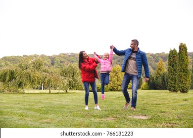 Happy Young Family Having Fun Together At The Park