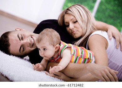 The Happy Young Family Inside The Flat