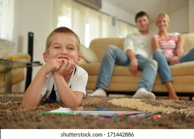 Happy Young Family With Kids In Bright Modern Living Room Have Fun And Looking Big Flat Lcd Tv