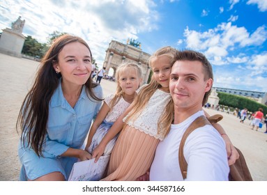 Happy Young Family With Map Of City Taking Selfie Background Famous Louvre In Paris