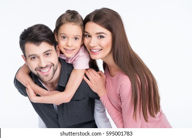 Happy Young Family With One Child Smiling At Camera Isolated On White