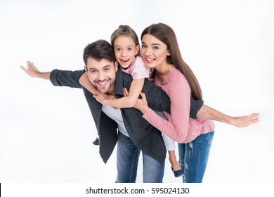 Happy young family with one child having fun together isolated on white
