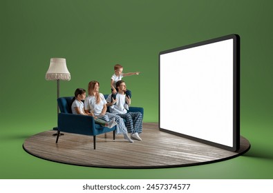 Happy young family in pajamas, man, woman and children sitting on sofa and looking at giant 3D model of tablet with empty screen. Entertainment. Concept of business, Internet services - Powered by Shutterstock