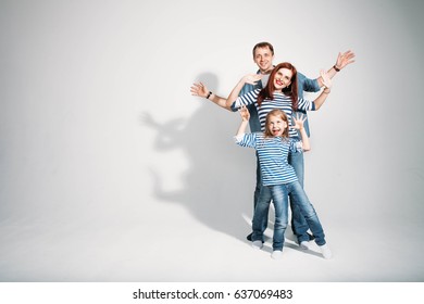 Happy Young Family Portrait Standing On White Background Isolated