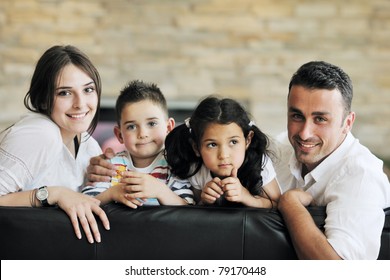 Happy Young Family Relax And Have Fun At Modern Home Indooor