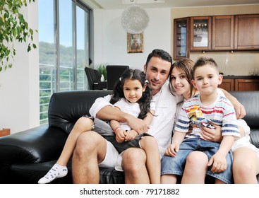 Happy Young Family Relax And Have Fun At Modern Home Indooor