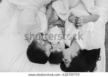 Similar – Image, Stock Photo Relaxed mother and sons embracing lying in the bed