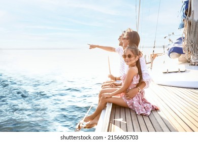 Happy Young Family Resting On Yacht