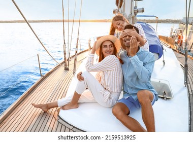 Happy Young Family Resting On Yacht