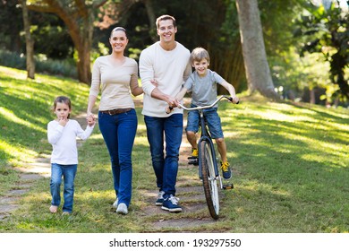 Happy Young Family Spend Quality Time Together In The Park