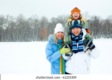 Happy Young Family Spending Time Outdoor In Winter (focus On The Father)