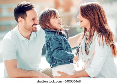 Happy Young Family Spending Time Together Outside.