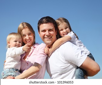 Happy Young Family With Two Children Outdoors