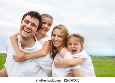 Happy Young Family With Two Children Outdoors