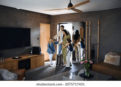 Happy young family with two children enetring room at luxury hotel, summer holiday. - Powered by Shutterstock