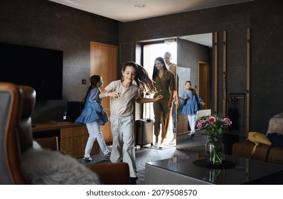 Happy young family with two children enetring room at luxury hotel, summer holiday. - Powered by Shutterstock