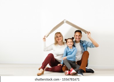 Happy Young Family Under A Safe Roof, Concept