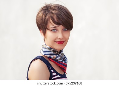 Happy Young Fashion Woman With Pixie Hair Style Walking Outdoor Stylish Female Model In Tank Top And Silk Scarf
