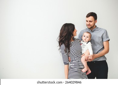 Happy Young Father, Mother And Cute Baby Boy Over White Background With Copy Space