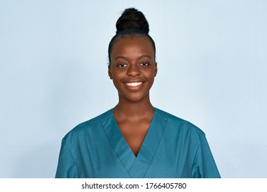 Happy young female african american scrub nurse wear blue uniform standing isolated on background. Black millennial woman medical student, intern, medic staff professional head shot close up portrait.