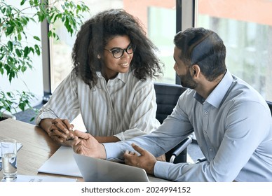 Happy Young Female African American Businesswoman With Clasped Hands Listening To Indian Executive Manager Ceo. Diverse Multiracial Professional Group Discussing Business Plan At Board Room Meeting.