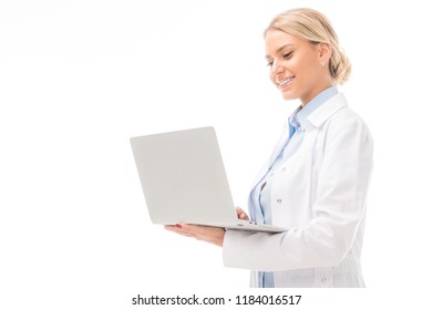 Happy Young Female Doctor Working With Laptop Isolated On White