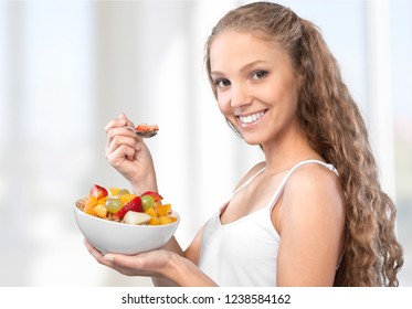 Happy young  female eating healthy food - Shutterstock ID 1238584162