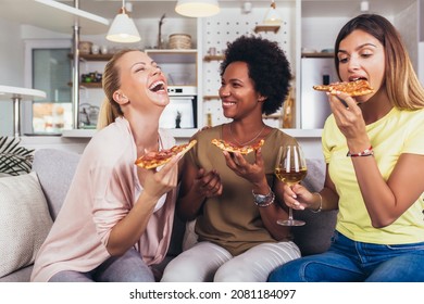 Happy Young Female Friends With Wine And Pizza On Sofa At Home. 