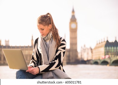 Happy young female with laptop in London. look in laptop - Shutterstock ID 605011781