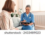 Happy young female nurse provide care medical service help support smiling mature woman at homecare medical visit, lady carer doctor give empathy encourage retired patient sit on sofa at home hospital