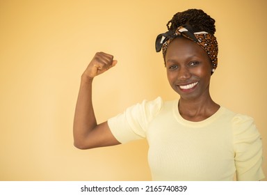 Happy young feminist woman showing her biceps  - Shutterstock ID 2165740839