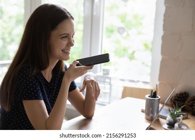 Happy Young Freelancer Gen Z Girl Talking On Mobile Phone On Speaker, Recording Audio Message, Using Virtual Voice Assistant For Internet Search, Giving Command To Online App