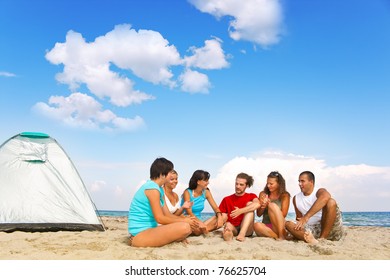 happy young friends camping on beach next tend