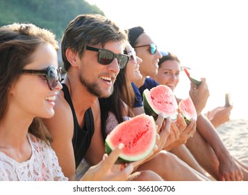 Happy Young Friends Eating Watermelon On Beach