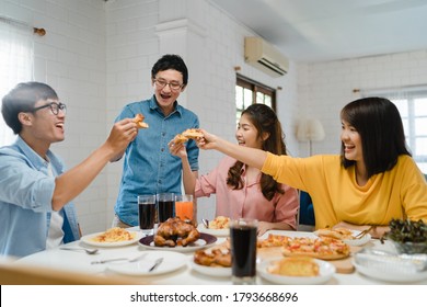 Happy Young Friends Group Having Lunch At Home. Asia Family Party Eating Pizza Food And Laughing Enjoying Meal While Sitting At Dining Table Together At House. Celebration Holiday And Togetherness.