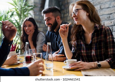 Happy Young Friends Hangout In Coffee Shop