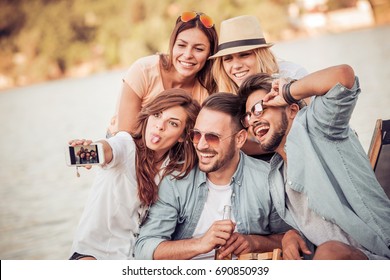 Happy Young Friends Having Fun On The Beach,taking Selfie.