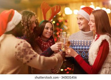 Happy Young Friends Toasting On Christmas Party