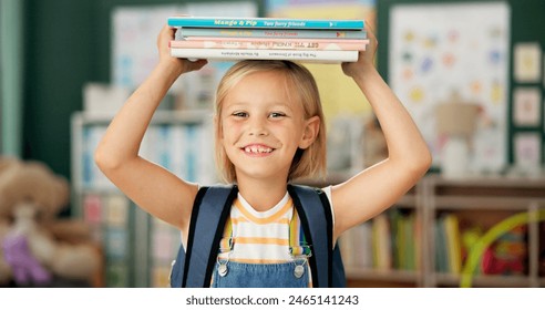 Happy, young girl and books on her head in kindergarten school for child development, growth and learning. Smile, female person or student with novel for story time with education, study and reading - Powered by Shutterstock