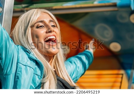happy young girl enjoying in amusement park