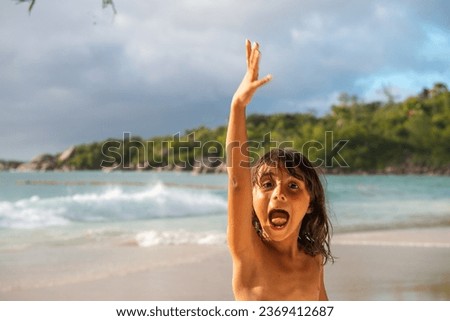 Happy young girl enjoying a beautiful tropical island.