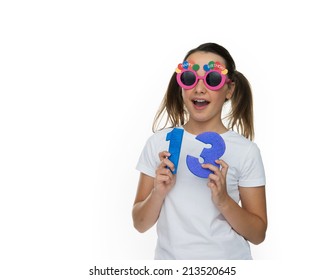 Happy Young Girl In Goofy Glasses Celebrating Being A Teenager Holding Up Two Numerals Showing She Has Turned Thirteen