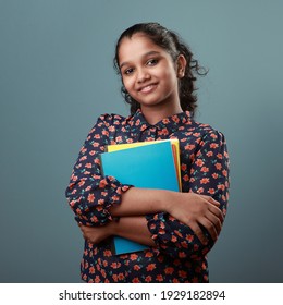 Happy Young Girl Holding Note Books In Her Hand