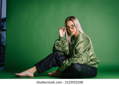 Happy Young Girl Sitting On Green Screen