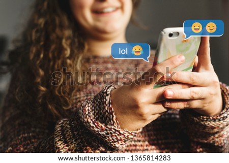 Happy young girl texting on her phone