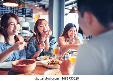 Happy Young Group Dining  At Restaurant