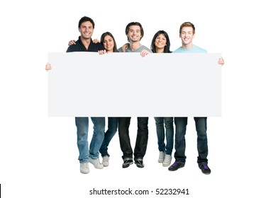 Happy Young Group Of People Standing Together And Holding A Blank Sign For Your Text, Isolated On White Background